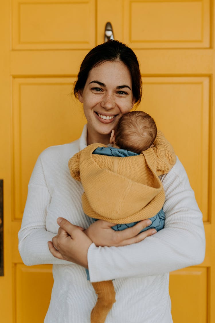 A Woman Carrying Her Baby