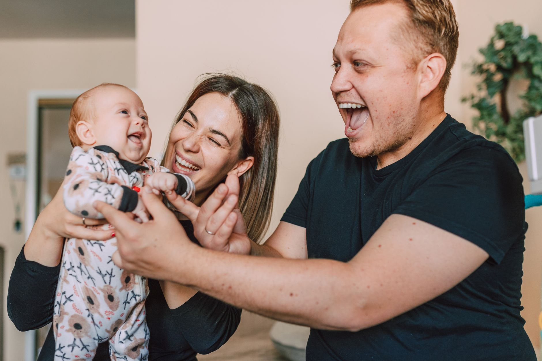 Parents laughing with their young child