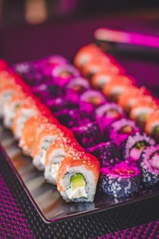 A colorful assortment of sushi rolls featuring salmon and rice on a modern plate.