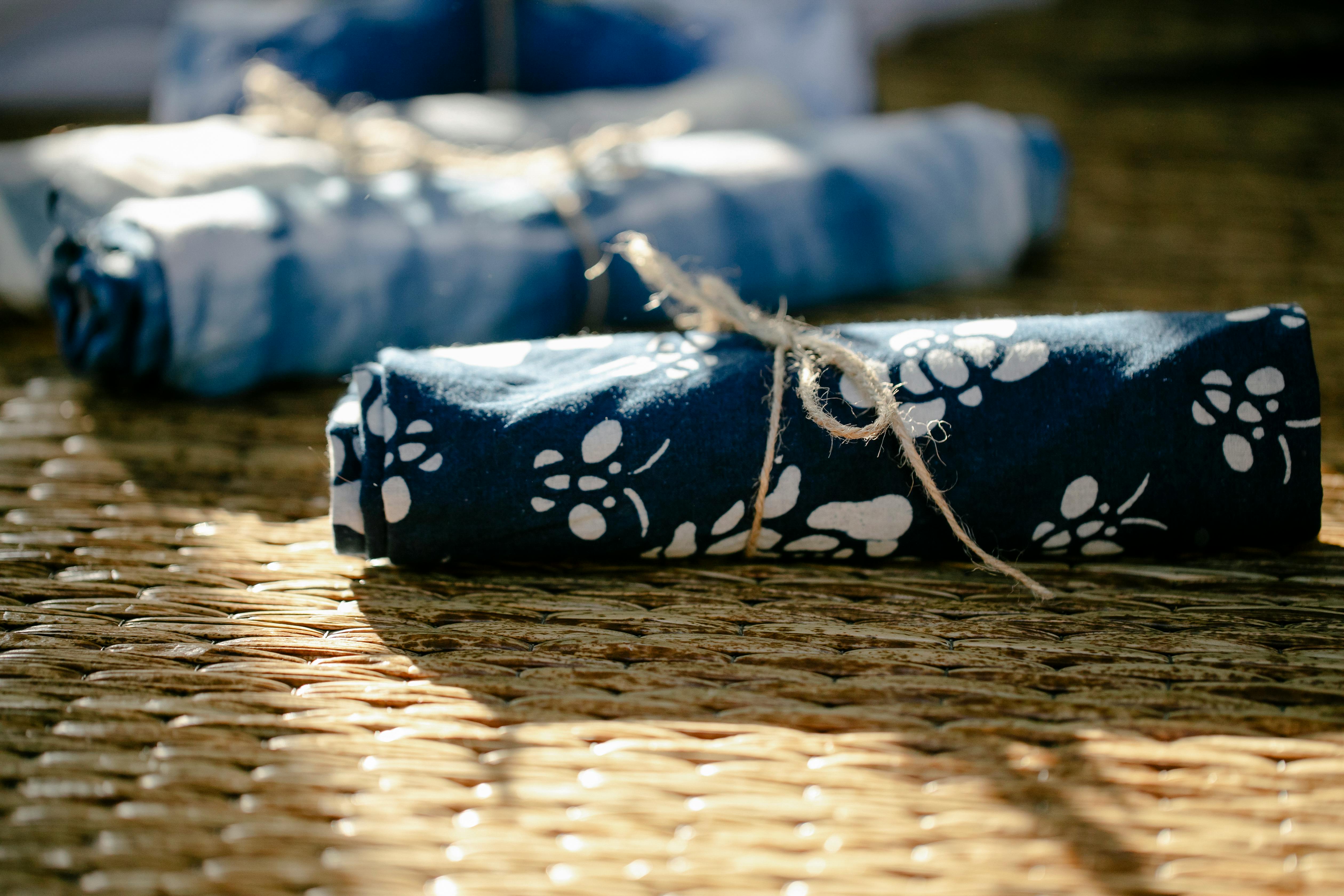 rolled textile on wicker table