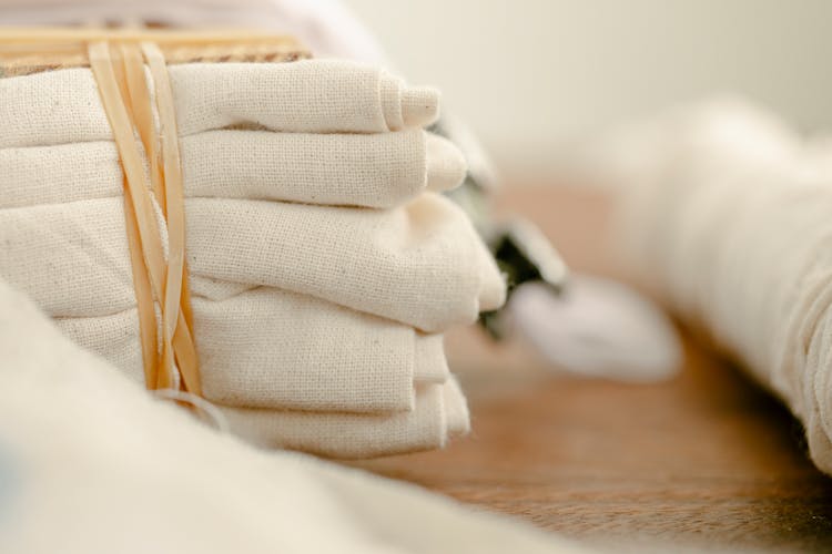 Tied Pile Of Flax Cloth On Wooden Table