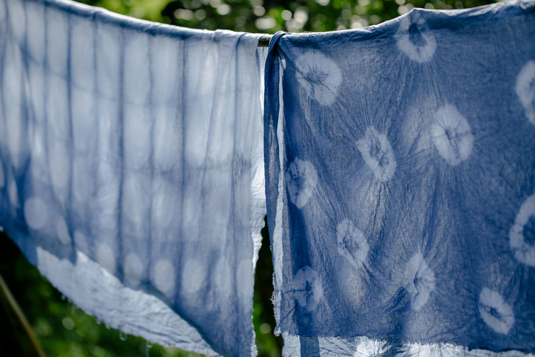 Clean fabric drying on clothesline on sunny day