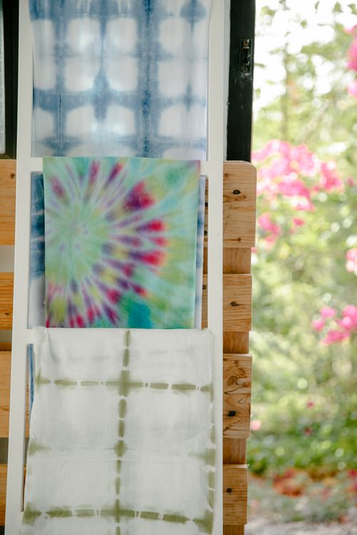 Fabric over-the-door organizer hanging on a wooden door with storage pockets