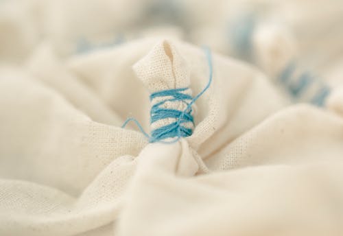 Beige fabric tied with light blue thread