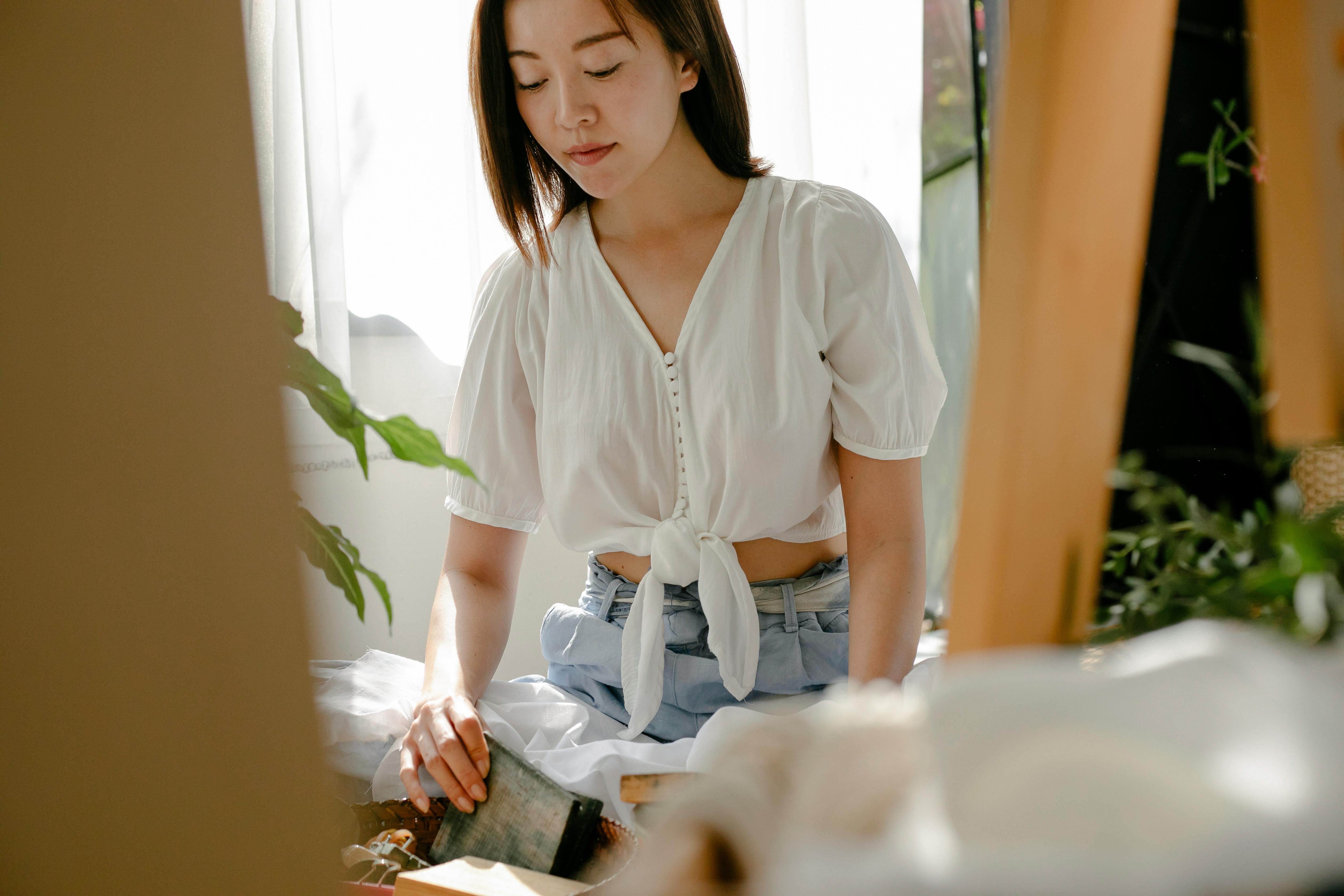 Crop ethnic artisan with shibori set at home