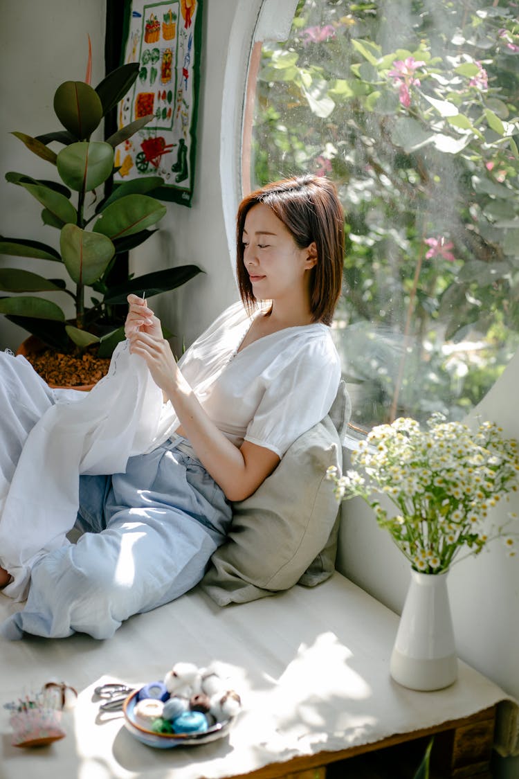 Ethnic Artisan Stitching Textile While Showing Shibori Technique At Home