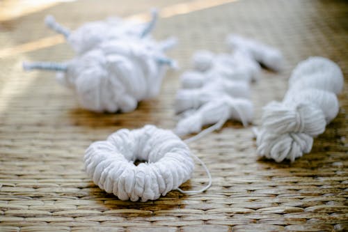 Tied fabrics scattered on rattan surface before creating shibori pattern