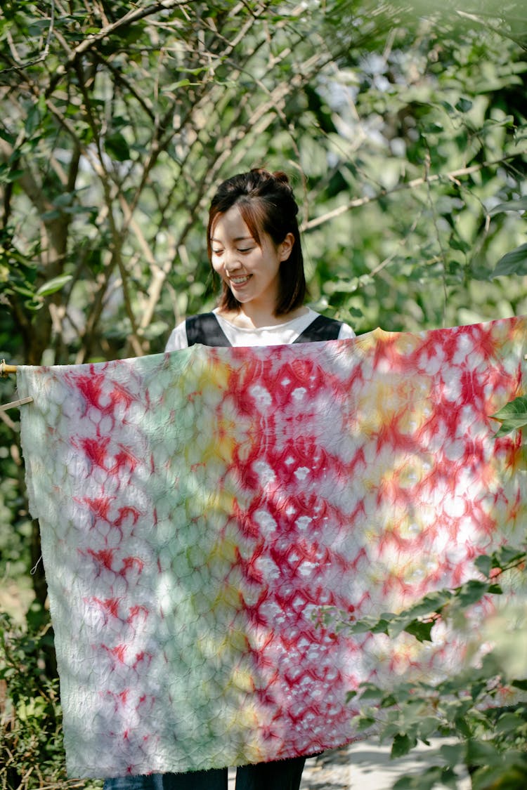 Woman Holding Colorful Tie Dyed Fabric