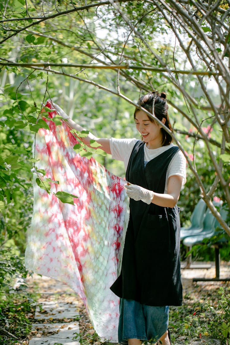 Woman Wearing Black Overall Holding A Clothe