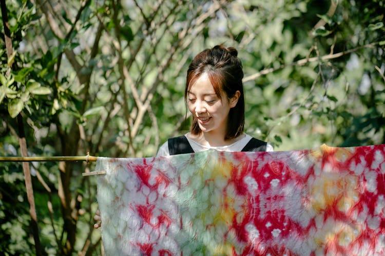 Smiling Woman Hanging Laundry