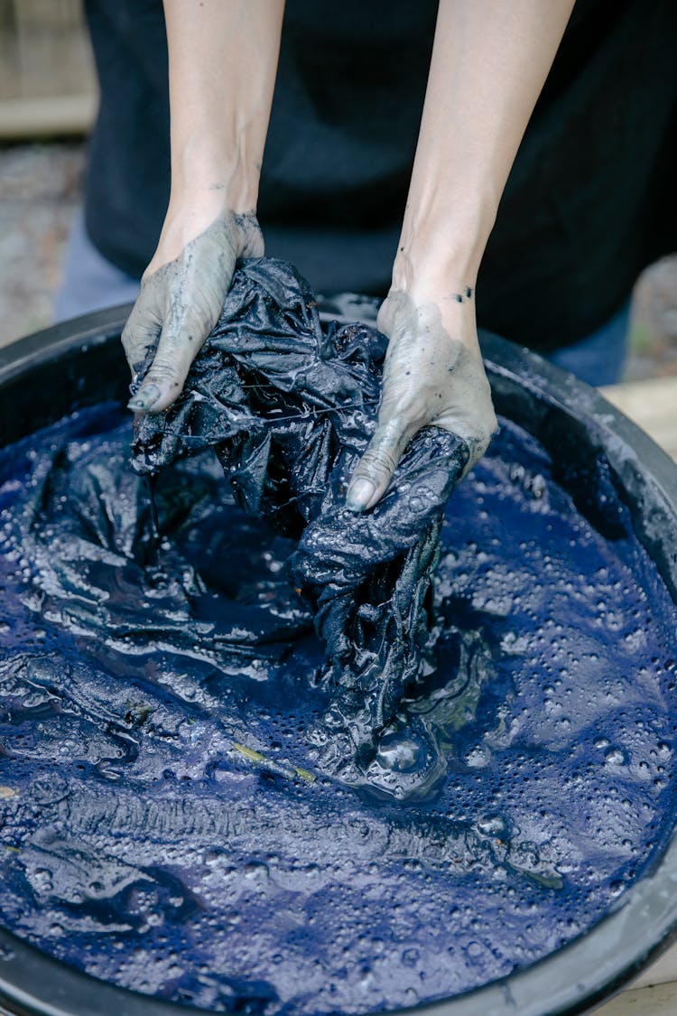 Close Up Of A Person Washing Clothes In A Bowl