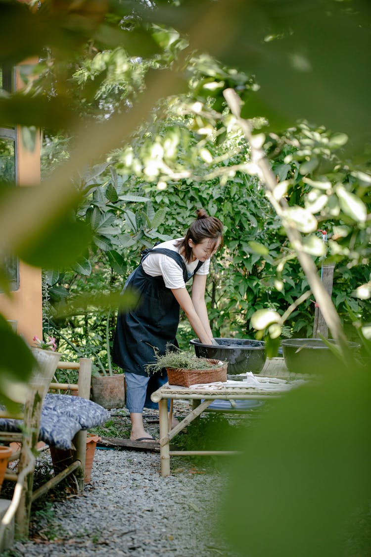 Woman Working By Table In Garden