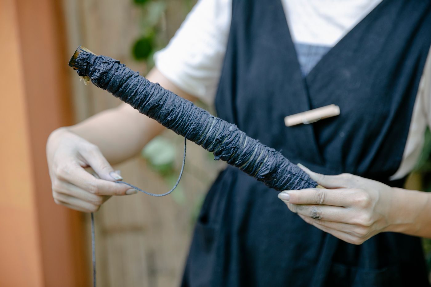 Hands looping thread in an artisan workshop