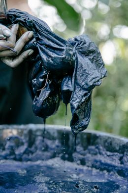 Dyed cloth dripping over the vat — Photo by Teona Swift on Pexels