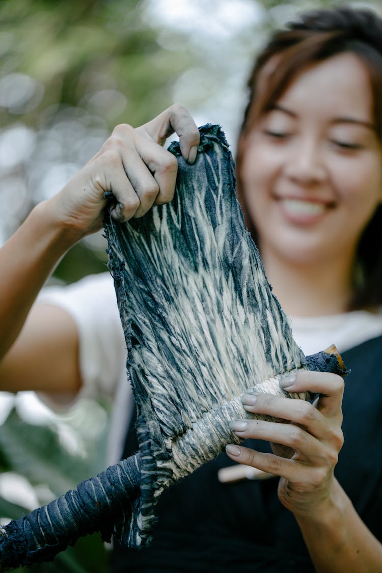 Woman Dyeing Fabric Blue By Hand