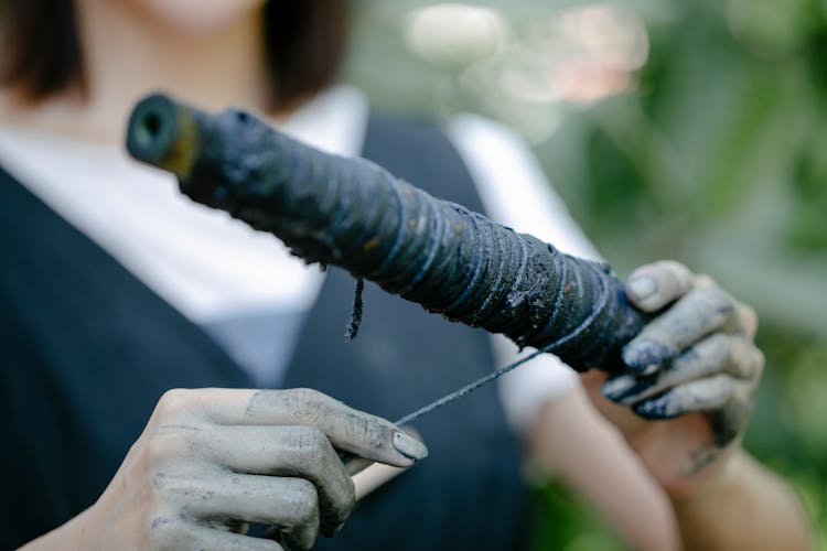 Close Up Of A Person Holding A Stick And A String