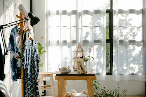 Clothes Hanging in a Rack in a Room 