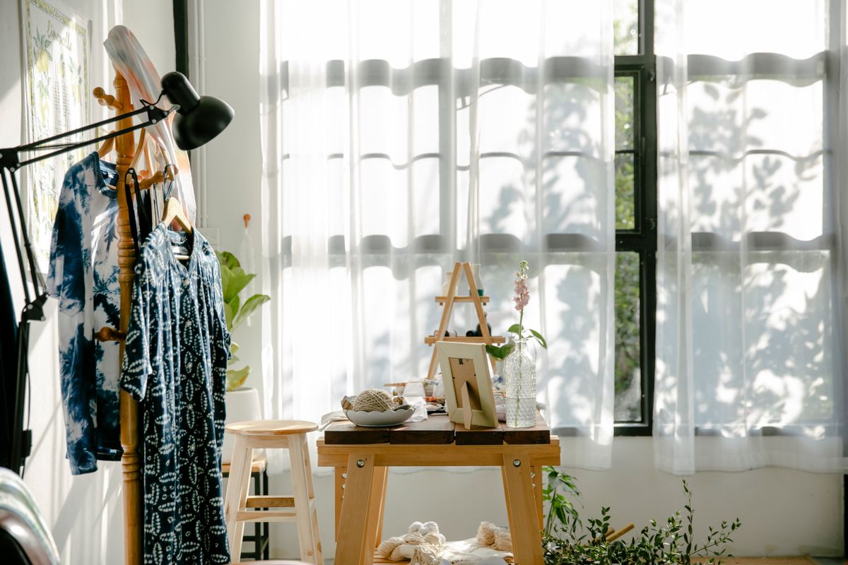 Freshly washed items airing indoors on a clothes rack in a bright, naturally lit room