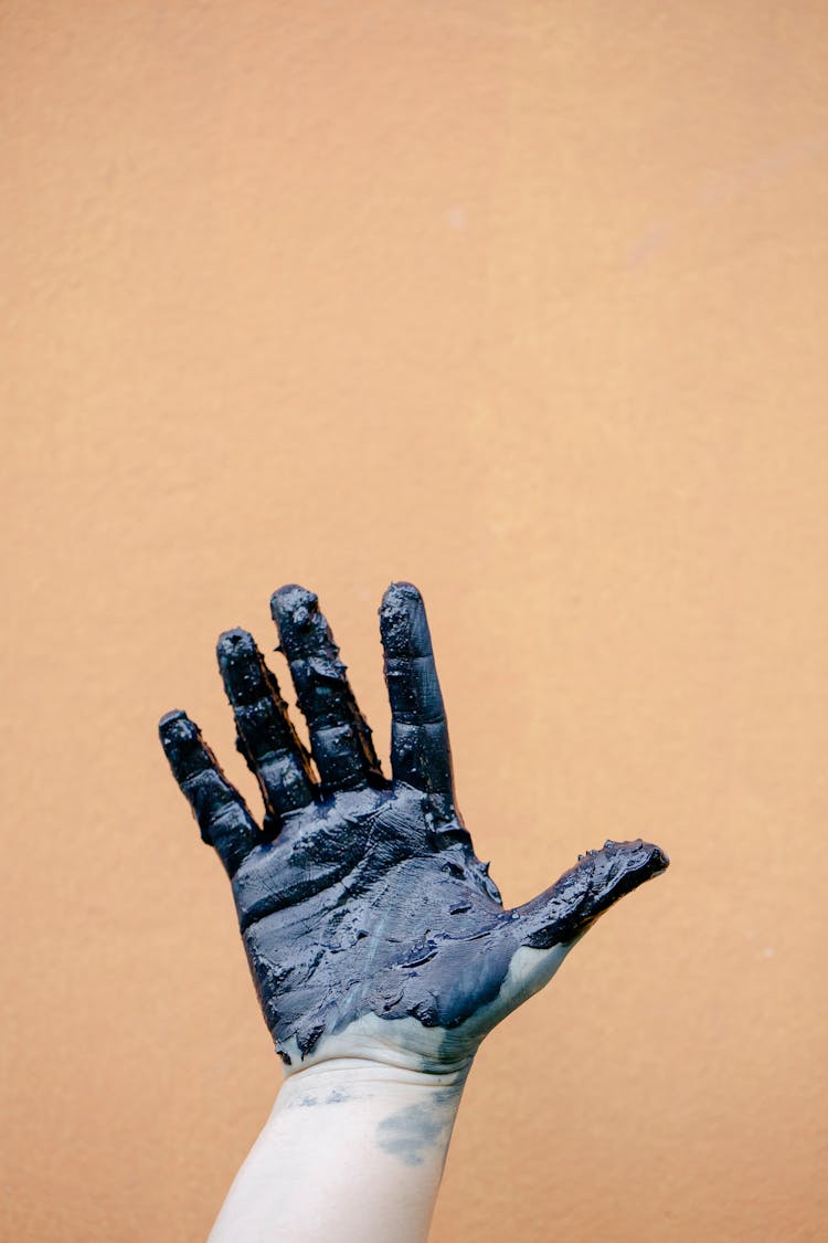 Palm Of A Hand Covered In Black Paint