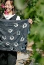 Smiling Asian woman with painted textile