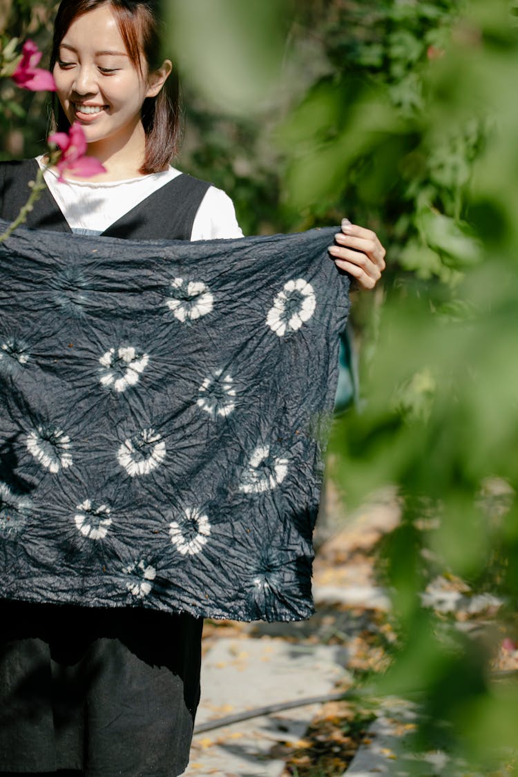 Smiling Asian Woman With Painted Textile