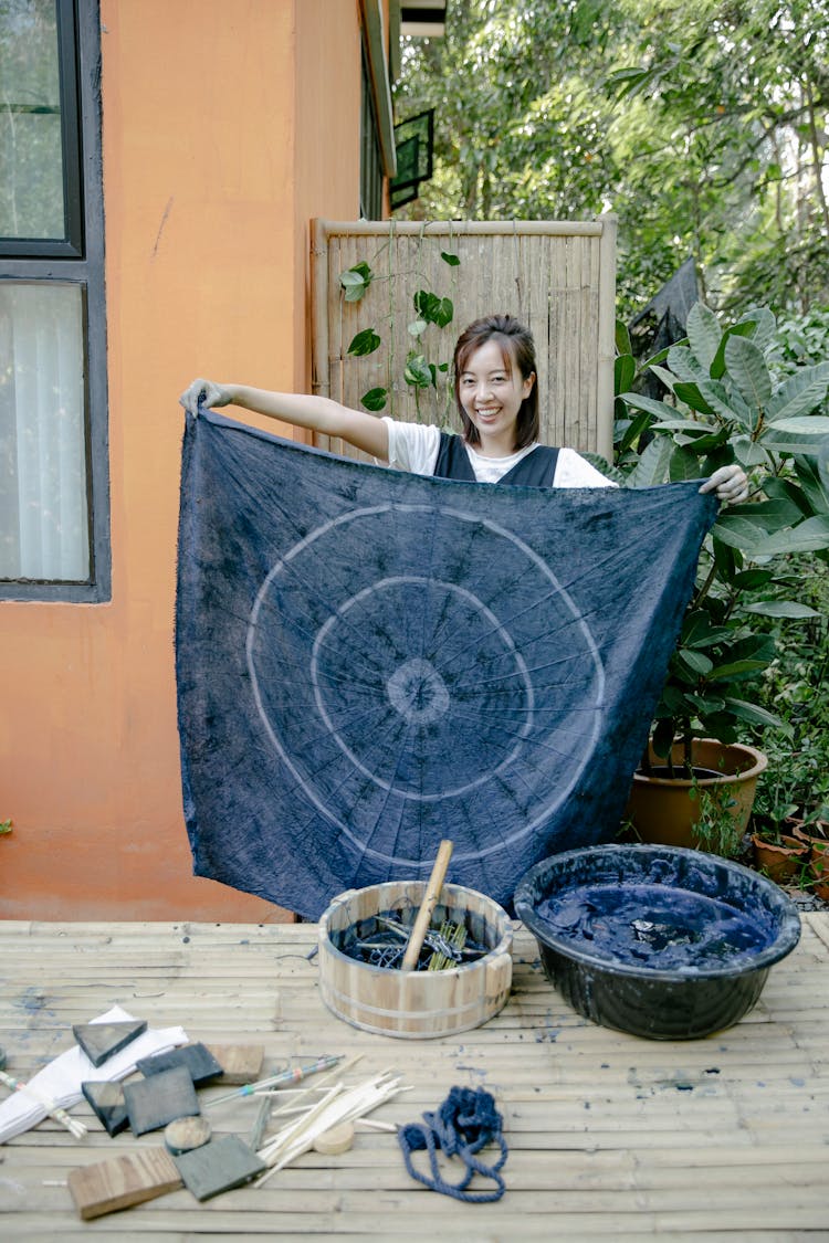 Cheerful Asian Woman With Painted Textile