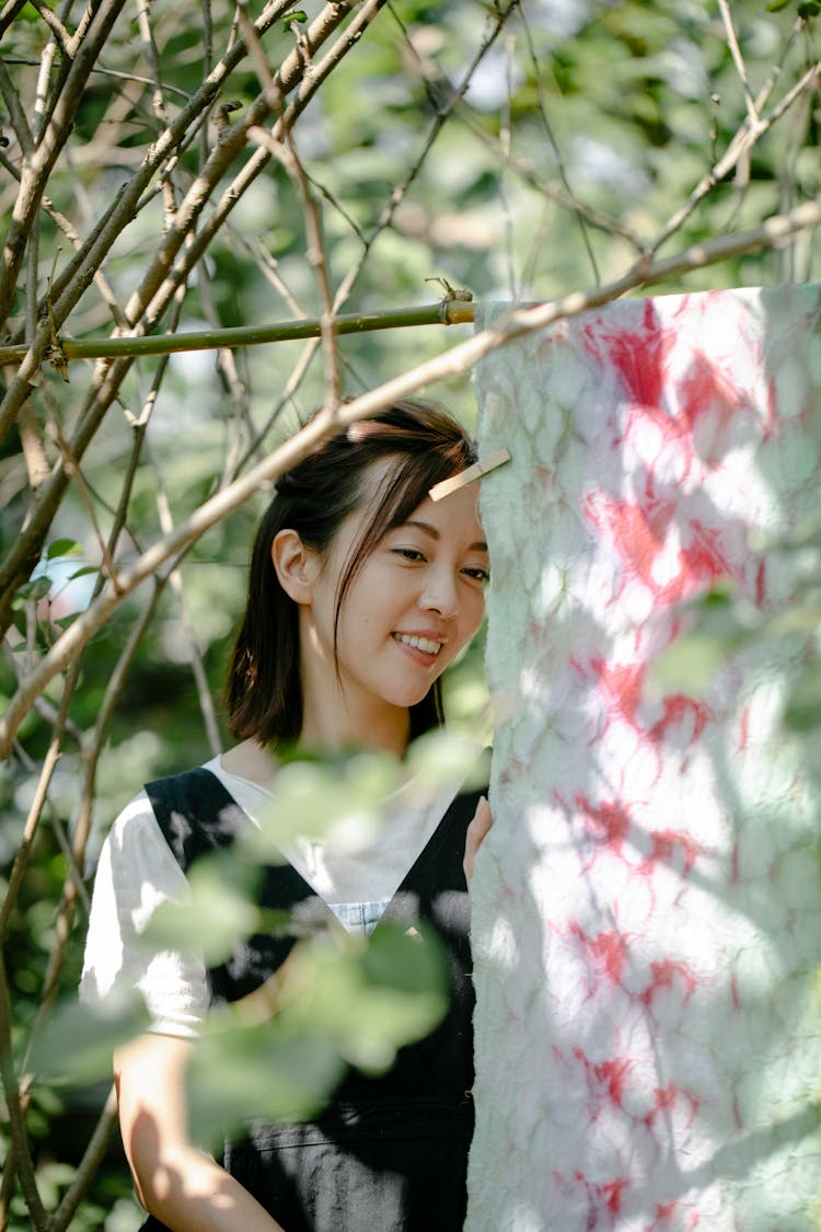 Delighted Asian Designer With Painted Textile In Countryside
