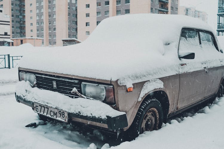 Old Car Covered With Snow