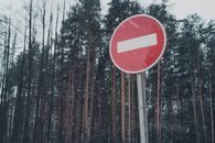 No Entry sign near snowy forest