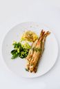 Fried Fish With Green Vegetables Side on White Ceramic Plate