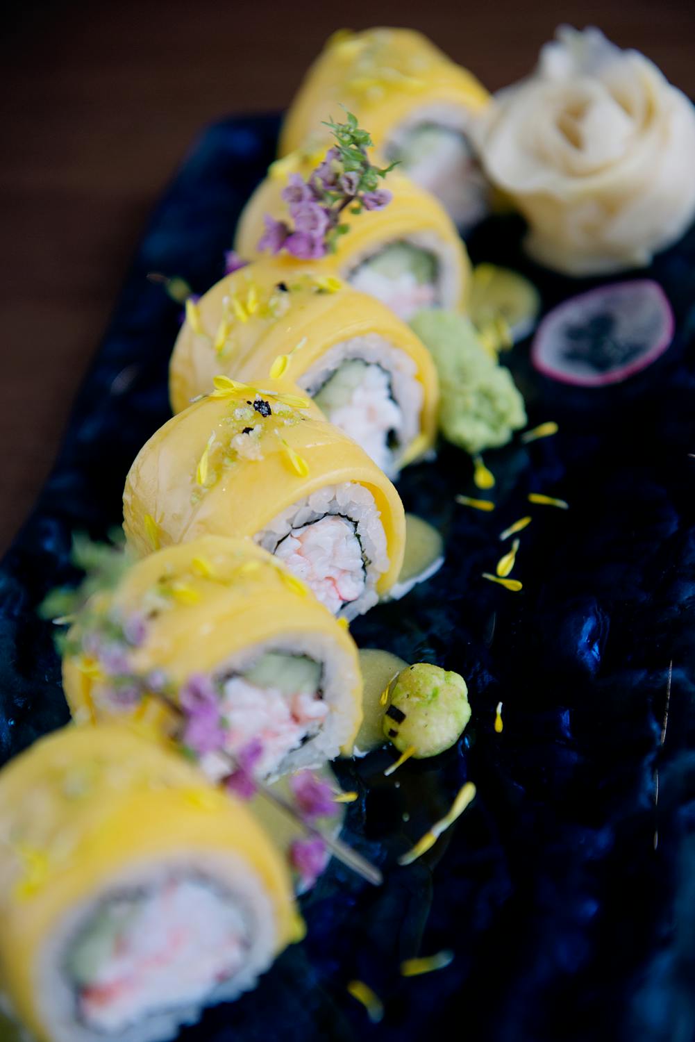 sushi covered in yellow fish