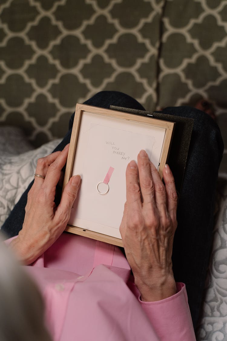 Person Holding A Picture Frame