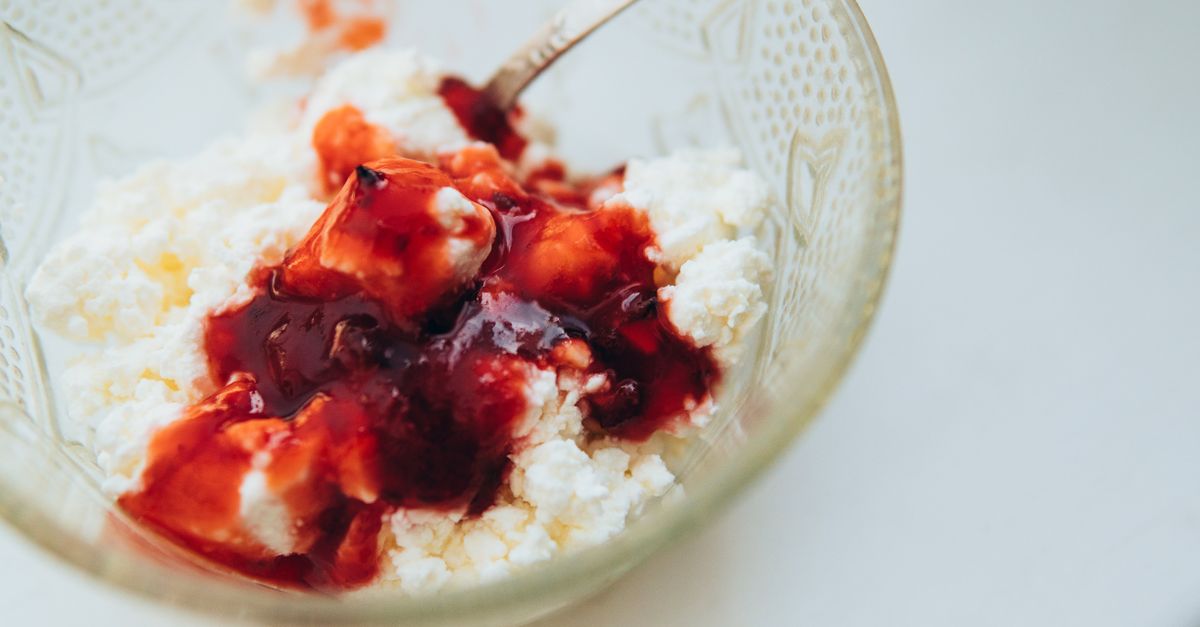 various bowls of cottage cheese with different toppings — savory and sweet — arranged on a marble countertop