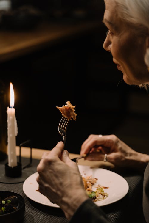 An Elderly Woman Having Dinner