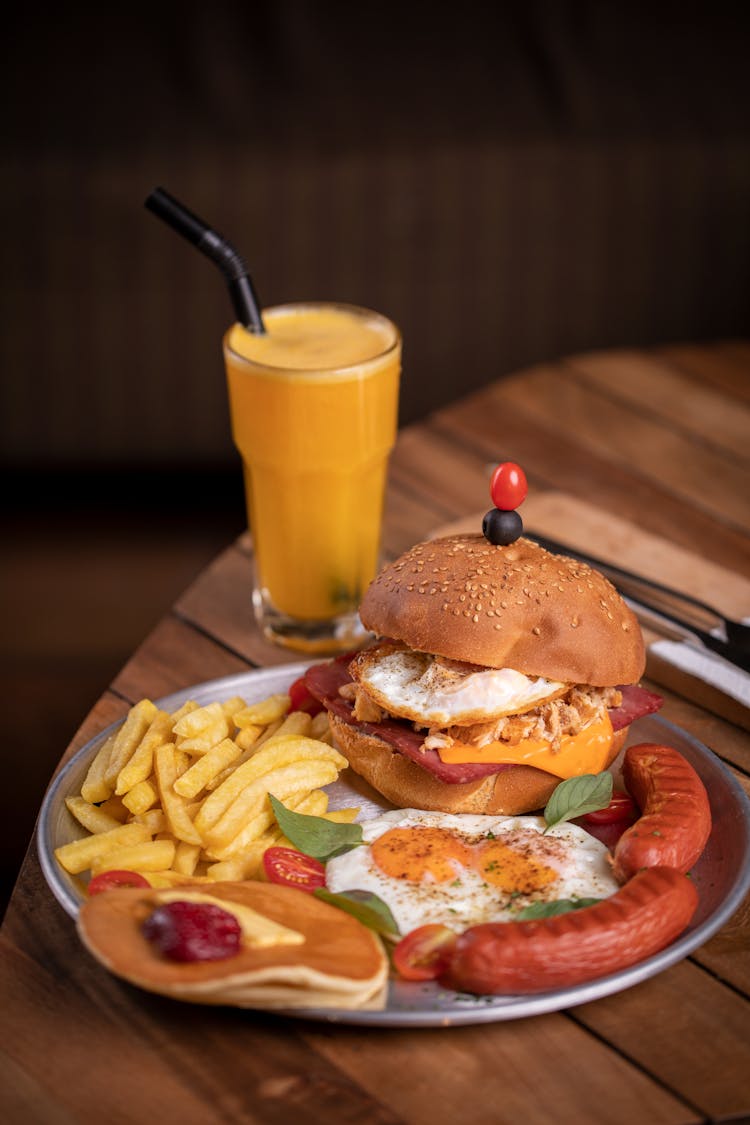 Burger And Fries On Plate With Fruit Shake