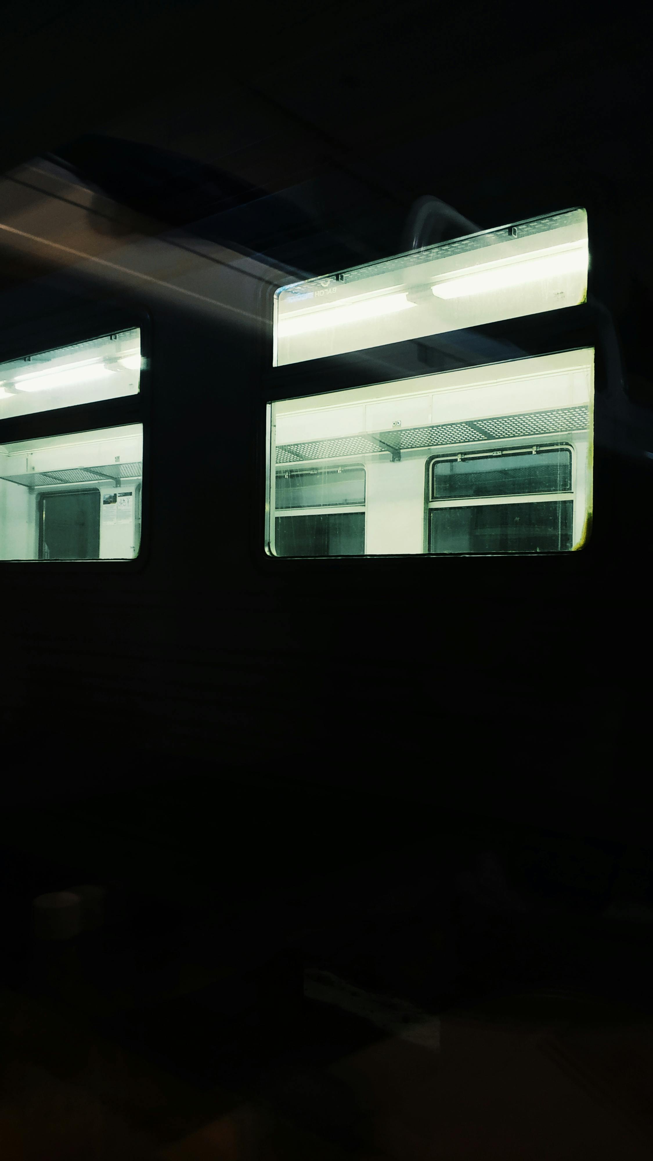 illuminated empty train in darkness