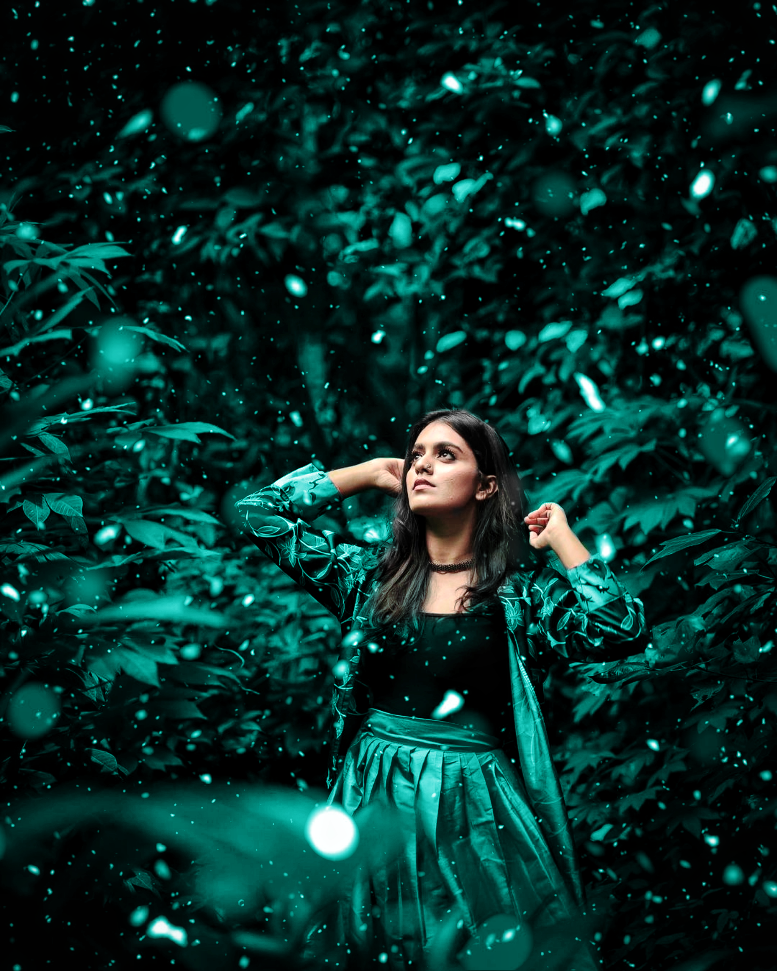 A captivating portrait of a woman amongst green foliage, evoking a serene, mystical atmosphere.
