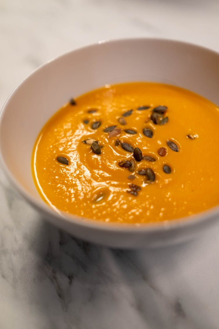 Orange Soup In White Ceramic Bowl