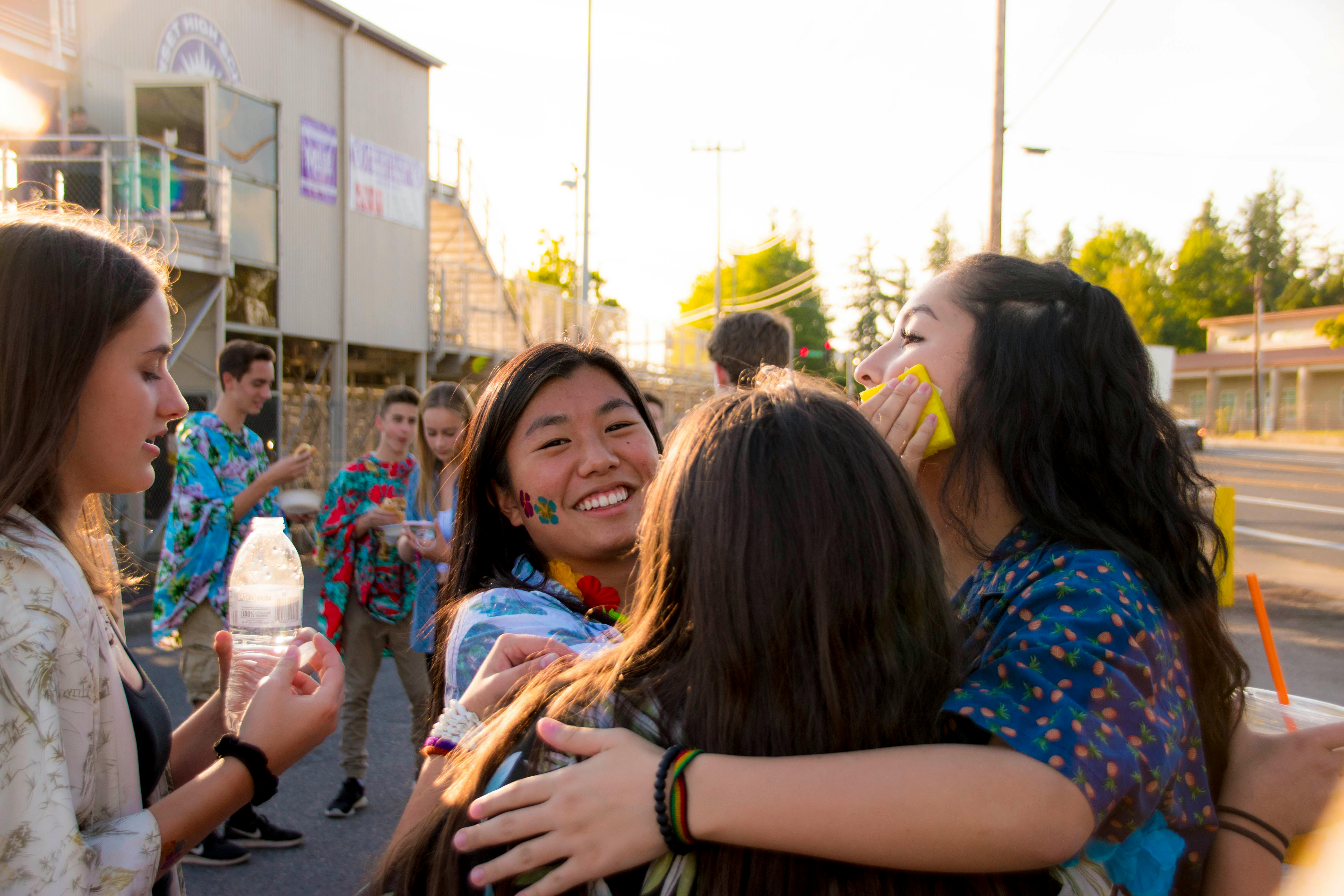A group of young friends sharing a joyful moment outdoors, expressing happiness and friendship.