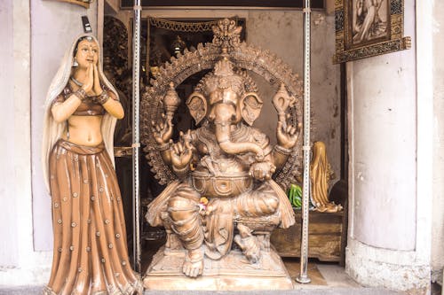 Free Gold Hindu Deity Statue on Gray Concrete Floor Stock Photo