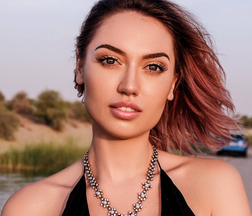Beautiful Woman Wearing a Silver Necklace Looking at The Camera