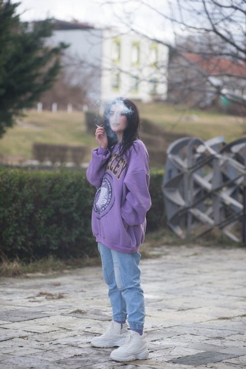 Girl in Baggy Violet Long Sleeve Shirt Smoking a Cigarette 