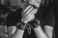 Man in Black Crew Neck T-shirt Wearing Black and Silver Bracelet