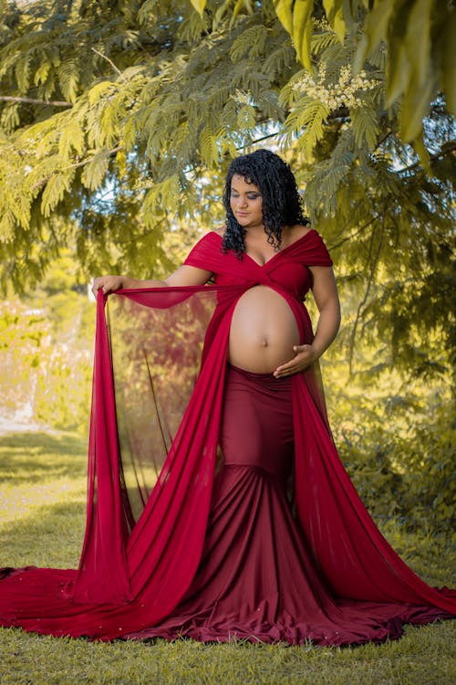 Free A Pregnant Woman in a Red Dress Stock Photo