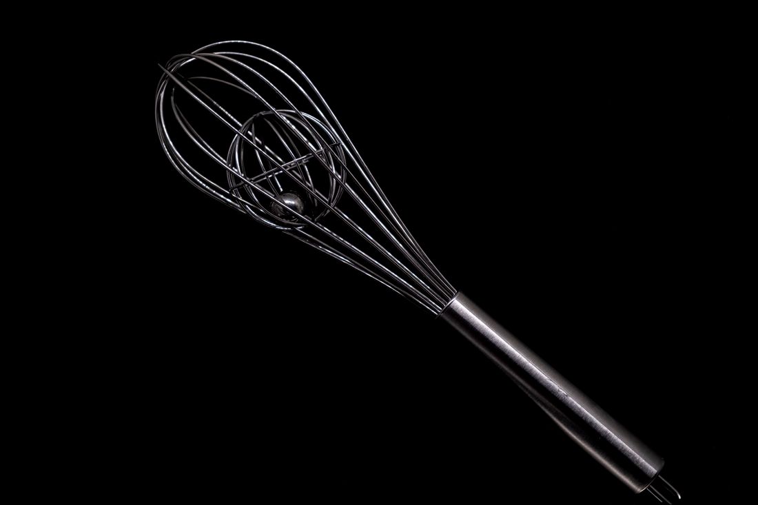 Stainless steel balloon whisk with an inner wire cage on black