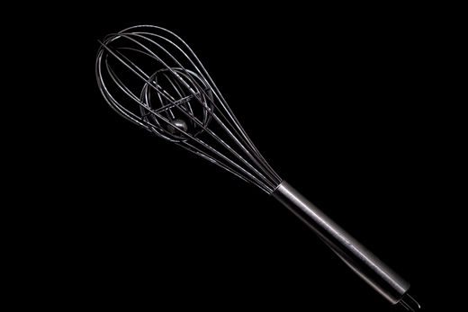 Stainless steel balloon whisk with an inner wire cage on black
