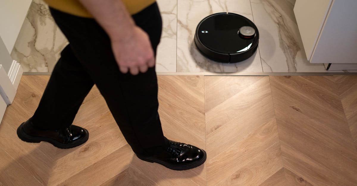Person Walking Near a Robotic Vacuum Cleaner on Marble Floor