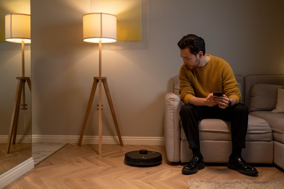 Man in Brown Sweater Sitting on White Sofa Chair | Photo by cottonbro from Pexels