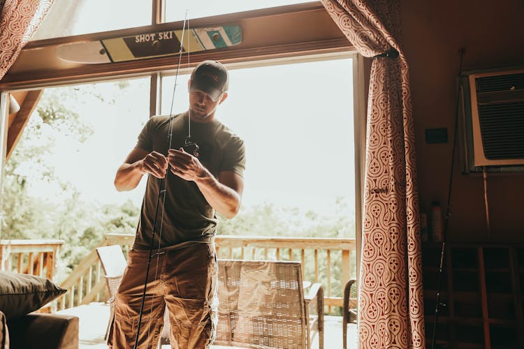 Man Fixing Fishing Rod