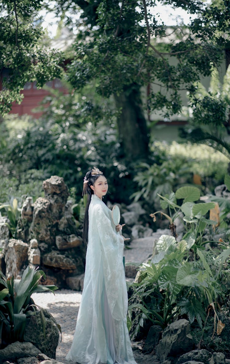 Woman In Traditional Chinese Dress Standing In Garden